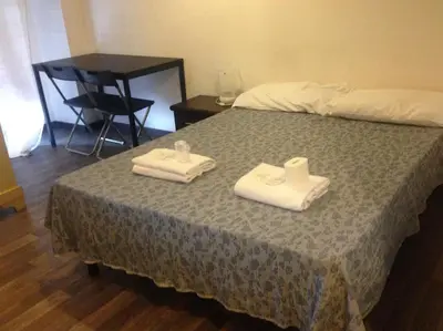 a bedroom with a bed with two towels on it at Radio Hotel in Rome