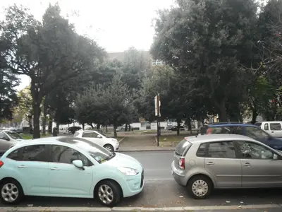 a couple of cars parked in a parking lot at Domi Aloisii in Rome