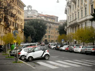 a small car parked on the side of a city street at Domi Aloisii in Rome