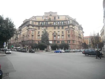 a large building with cars parked in front of it at Domi Aloisii in Rome