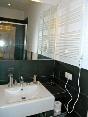 a bathroom with a white sink and a mirror at Domi Aloisii in Rome