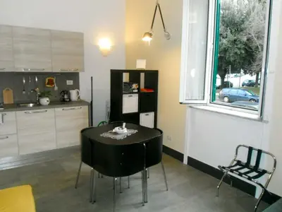 a kitchen with a black table and a window at Domi Aloisii in Rome