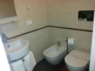 a bathroom with a sink and a toilet at Manila Inn in Rome