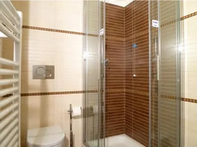 a bathroom with a glass shower with a toilet at Manila Inn in Rome