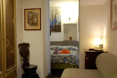 a room with a bedroom with a bed and a mirror at Villino Corbelli B&B in Rome
