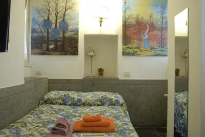 a person laying on a bed in a room at Villino Corbelli B&B in Rome
