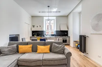a living room with a couch and a kitchen at Domus in Piazza del Popolo in Rome