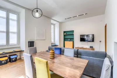 a dining room with a table and a couch at Domus in Piazza del Popolo in Rome