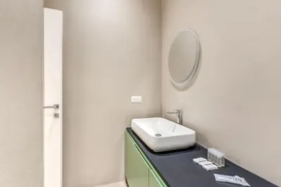 a bathroom with a sink and a mirror on a counter at Domus in Piazza del Popolo in Rome