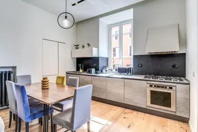 a kitchen and dining room with a table and chairs at Domus in Piazza del Popolo in Rome