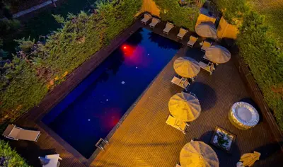 an overhead view of a swimming pool with umbrellas at Black Hotel in Rome