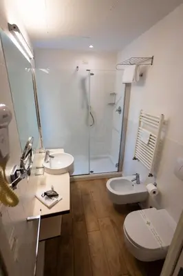 a bathroom with two sinks and a shower and a toilet at Black Hotel in Rome