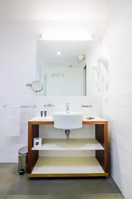 a bathroom with a sink and a mirror at Black Hotel in Rome
