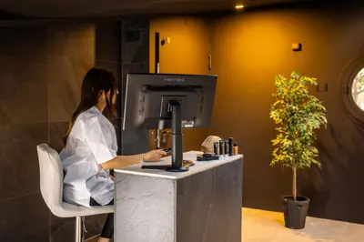 a woman standing at a counter with a coffee machine at Black Hotel in Rome