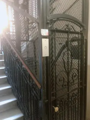 an iron gate on a stairway with a door at Hostel Cosmos in Rome