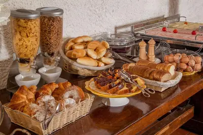 a table topped with baskets of bread and pastries at Hotel Colosseum in Rome
