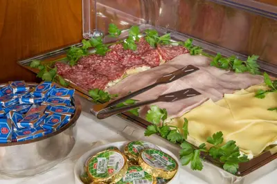 a table topped with meat and cheese and chips at Best Western Hotel Astrid in Rome