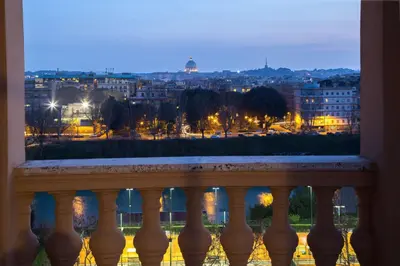 a view of a city from a balcony at night at Best Western Hotel Astrid in Rome