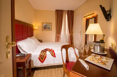 a hotel room with a bed and a desk with a table sidx sidx at Best Western Hotel Astrid in Rome
