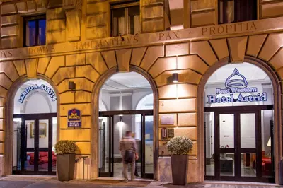 a man walks past a hotel australia building at Best Western Hotel Astrid in Rome