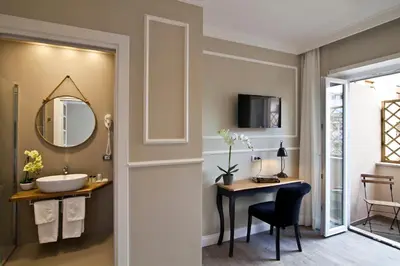 a bathroom with a sink and a desk with a mirror at Seven Suites in Rome