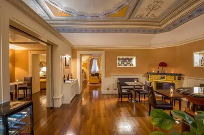 a dining room with tables and chairs and a ceiling at La Residenza in Rome