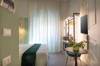 a hotel room with a bed and a table with a table sidx sidx at New Morpheus Rooms in Rome