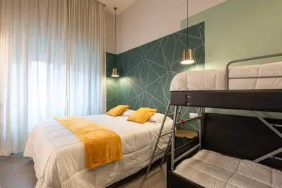 a bedroom with a bunk bed with yellow pillows at New Morpheus Rooms in Rome