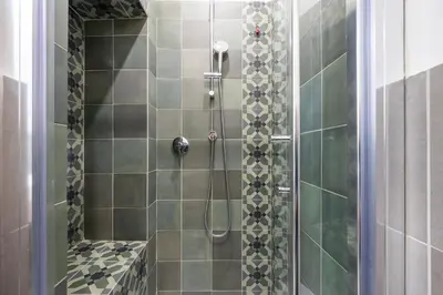 a bathroom with a shower with a glass door at New Morpheus Rooms in Rome