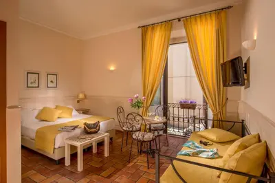 a hotel room with two beds and a tv at Aenea Inn in Rome