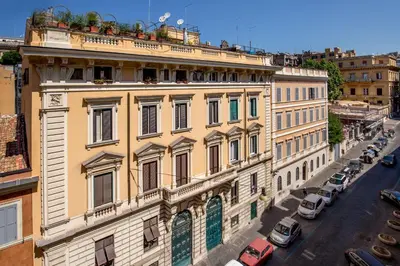 a large building on a city street with cars parked at Aenea Inn in Rome