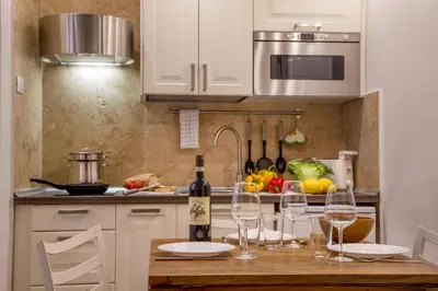 a kitchen with a table with wine glasses on it at Aenea Inn in Rome