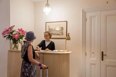 two women standing at a counter in a room at Aenea Inn in Rome