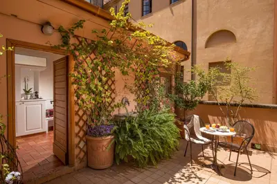 a patio with a table and some plants at Aenea Inn in Rome