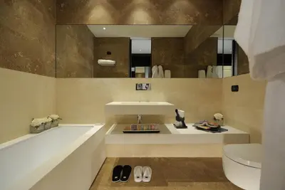 a bathroom with a tub and a sink and a toilet at Alpi Hotel in Rome
