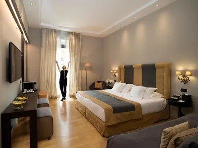 a woman is standing in a hotel room at Alpi Hotel in Rome