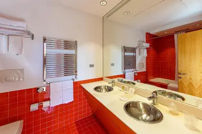 a bathroom with two sinks and a large mirror at Albani Hotel Roma in Rome