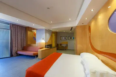 a hotel room with a bed and a couch at Albani Hotel Roma in Rome