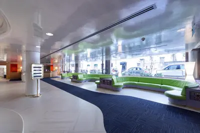 a waiting room with green couches in a building at Albani Hotel Roma in Rome