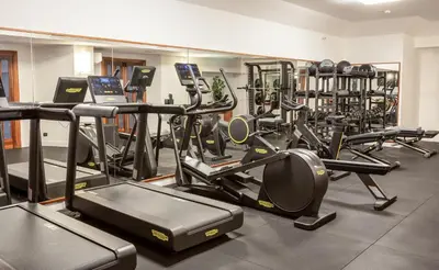 a gym with a bunch of treadmills and machines at Grand Hotel Tiberio in Rome