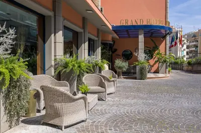 a row of wicker chairs sitting outside of a building at Grand Hotel Tiberio in Rome
