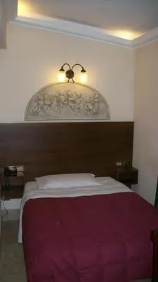 a bedroom with a large bed with a red blanket at Hotel Prati in Rome