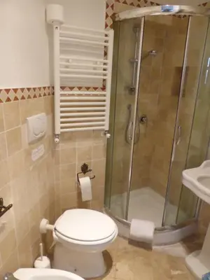 a bathroom with a shower and a toilet and a sink at Hotel Prati in Rome