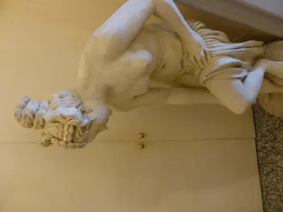 a statue of a woman laying on the ceiling at Hotel Prati in Rome
