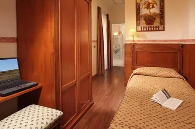 a bedroom with a bed with a book on it at Hotel Alessandrino in Rome