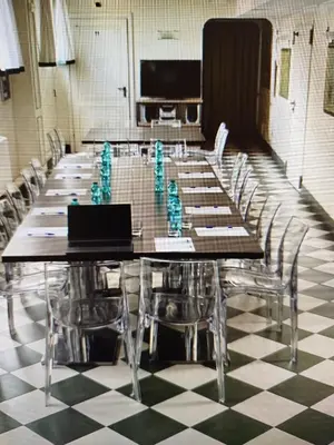 a conference room with a long table with chairs and a laptop at Hotel Alessandrino in Rome