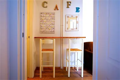 a table and two stools in a room at Vetrina Holidays Apartment Navona in Rome
