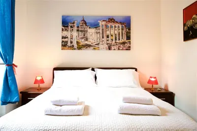 a bedroom with a white bed with two pillows at Vetrina Holidays Apartment Navona in Rome