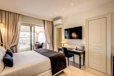 a hotel room with a bed and a desk at Hotel Domus Mea in Rome