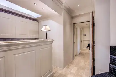 a hallway with white walls and a skylight at Hotel Domus Mea in Rome